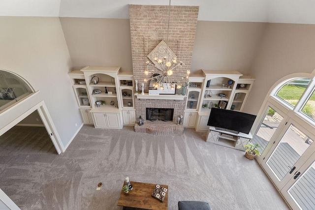 2570 Jewett Rd, Powell, OH 43065 - carpeted living room with high vaulted ceiling, a chandelier, and a fireplace