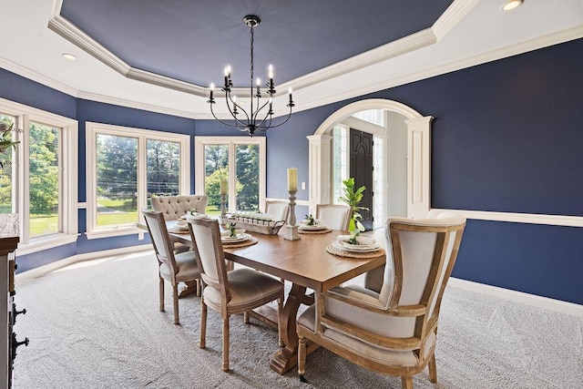 2570 Jewett Rd, Powell, OH 43065 - dining area with a raised ceiling, carpet, arched walkways, a chandelier, and ornamental molding