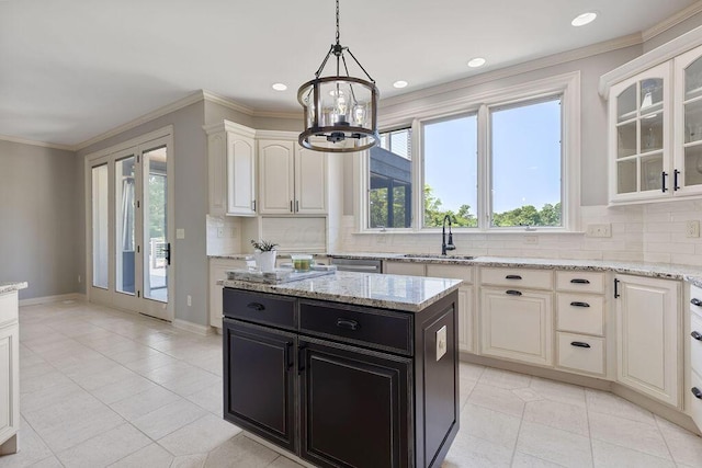 2570 Jewett Rd, Powell, OH 43065 - kitchen featuring dark cabinetry, tasteful backsplash, a chandelier, glass insert cabinets, and light tile patterned floors