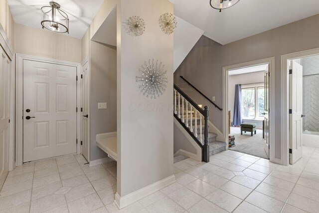 2570 Jewett Rd, Powell, OH 43065 - foyer with stairs and light tile patterned floors