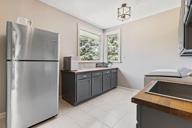 2570 Jewett Rd, Powell, OH 43065 - kitchen featuring freestanding refrigerator and light tile patterned floors