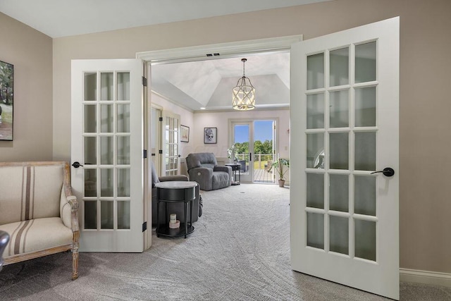 2570 Jewett Rd, Powell, OH 43065 - hallway with french doors, carpet floors, and a chandelier