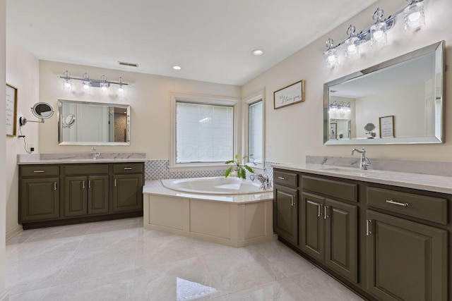 2570 Jewett Rd, Powell, OH 43065 - bathroom with two vanities, a garden tub, and recessed lighting
