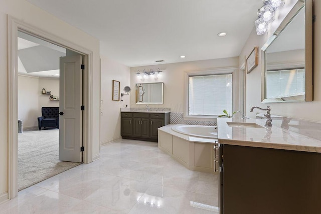 2570 Jewett Rd, Powell, OH 43065 - full bathroom with two vanities, a bath, and recessed lighting