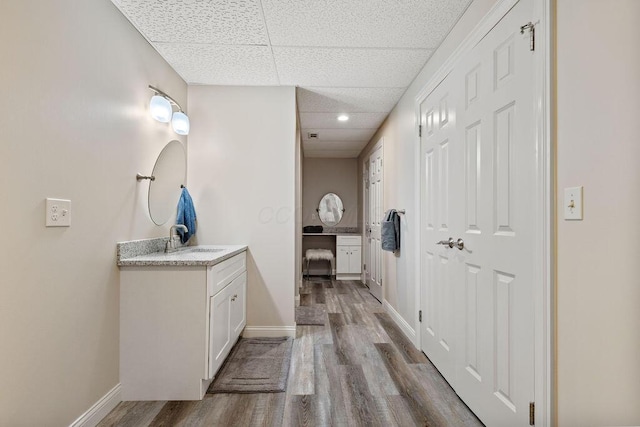 2570 Jewett Rd, Powell, OH 43065 - bathroom featuring vanity, a paneled ceiling, and wood finished floors