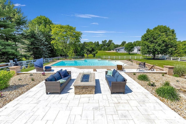2570 Jewett Rd, Powell, OH 43065 - view of swimming pool with an outdoor living space with a fire pit, a patio, a fenced backyard, and view of wooded area
