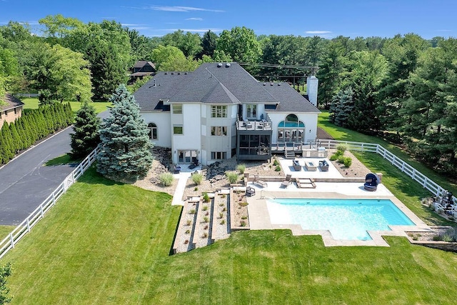 2570 Jewett Rd, Powell, OH 43065 - rear view of house featuring a balcony, a fenced backyard, a patio area, and a chimney