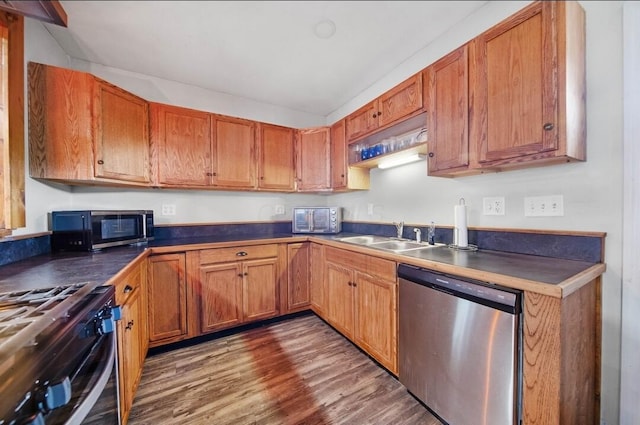 926 Harmon Ave, Columbus, OH 43223 - kitchen featuring stainless steel appliances, a sink, dark countertops, and wood finished floors