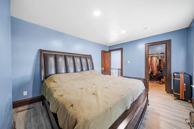 926 Harmon Ave, Columbus, OH 43223 - bedroom featuring baseboards, light wood-style flooring, a walk in closet, recessed lighting, and a closet