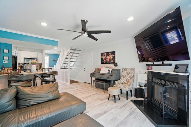 2201 Teardrop Ave Unit 34A, Columbus, OH 43235 - living room with stairway, light wood-type flooring, a ceiling fan, ornamental molding, and recessed lighting