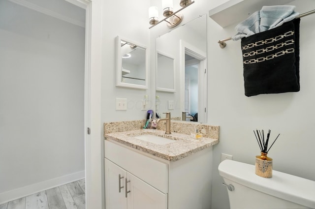 2201 Teardrop Ave Unit 34A, Columbus, OH 43235 - bathroom with toilet, vanity, wood finished floors, and baseboards