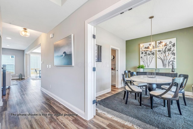 266 Willow Way, Newark, OH 43055 - dining space featuring a chandelier, wood finished floors, and baseboards