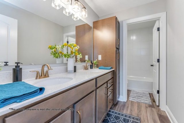 266 Willow Way, Newark, OH 43055 - bathroom with double vanity, wood finished floors, and a chandelier