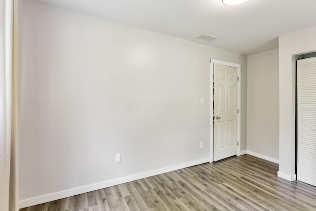 8175 Vore Ridge Rd, Athens, OH 45701 - unfurnished bedroom with wood finished floors, a closet, and baseboards