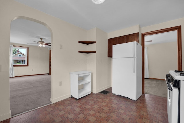 2007 Dunbar Dr, Columbus, OH 43224 - kitchen with freestanding refrigerator, gas range oven, open shelves, ceiling fan, and brick patterned floors