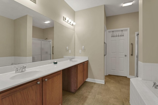 6370 Portrait Cir Unit 103, Westerville, OH 43081 - full bathroom featuring a shower stall, double vanity, a garden tub, baseboards, and tile patterned flooring