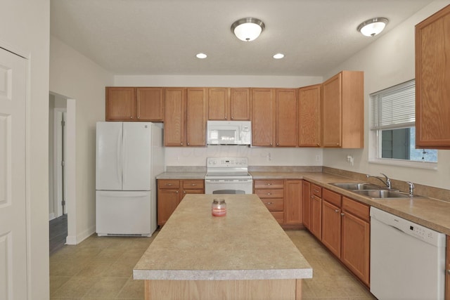 6370 Portrait Cir Unit 103, Westerville, OH 43081 - kitchen featuring white appliances, a sink, a kitchen island, light countertops, and recessed lighting