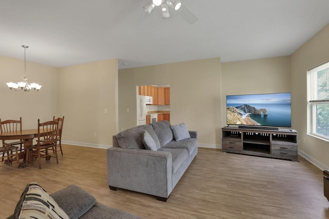 6370 Portrait Cir Unit 103, Westerville, OH 43081 - living area featuring light wood-type flooring, ceiling fan, a chandelier, and baseboards