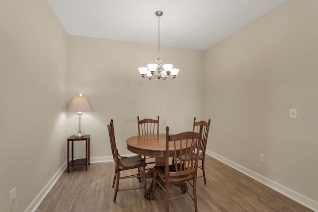 6370 Portrait Cir Unit 103, Westerville, OH 43081 - dining room with light wood finished floors, a chandelier, and baseboards