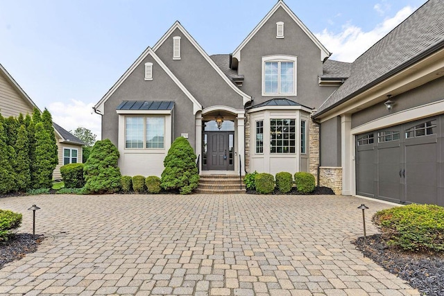 5753 Aster Way, Galena, OH 43021 - french country home with stucco siding, decorative driveway, stone siding, a standing seam roof, and an attached garage