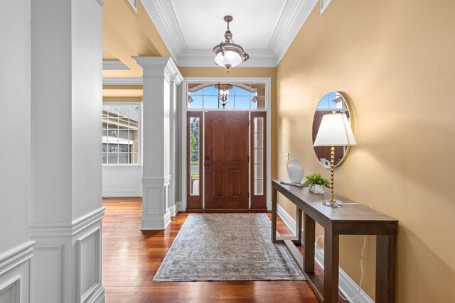 5753 Aster Way, Galena, OH 43021 - entrance foyer featuring decorative columns, a chandelier, wood finished floors, and ornamental molding