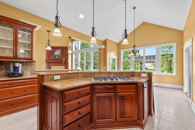 5753 Aster Way, Galena, OH 43021 - kitchen featuring stainless steel gas stovetop, backsplash, light tile patterned floors, plenty of natural light, and vaulted ceiling