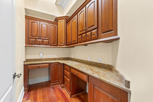 5753 Aster Way, Galena, OH 43021 - kitchen featuring dark wood-style flooring, light stone countertops, brown cabinetry, and baseboards