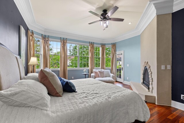 5753 Aster Way, Galena, OH 43021 - bedroom featuring dark wood finished floors, crown molding, baseboards, a fireplace with raised hearth, and ceiling fan