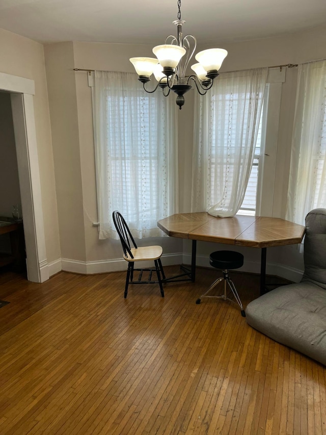 170 E Maynard Ave, Columbus, OH 43202 - dining area featuring a chandelier, baseboards, and hardwood / wood-style floors