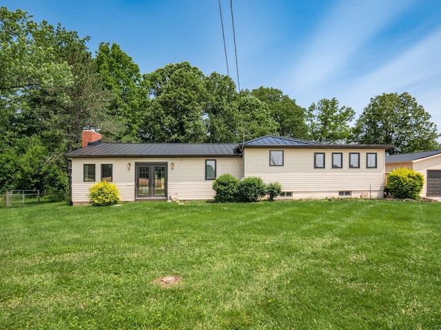 12609 Fancher Rd, Westerville, OH 43082 - view of front of home featuring french doors, a chimney, a standing seam roof, and a metal roof