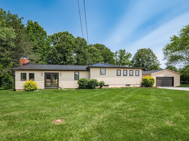 12609 Fancher Rd, Westerville, OH 43082 - view of front facade with french doors, a front lawn, a detached garage, and a standing seam roof
