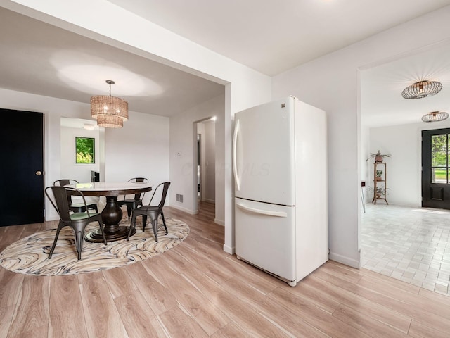 12609 Fancher Rd, Westerville, OH 43082 - dining room featuring light wood-type flooring and a chandelier