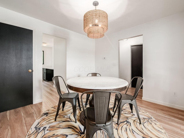 12609 Fancher Rd, Westerville, OH 43082 - dining area featuring a chandelier and light wood-type flooring