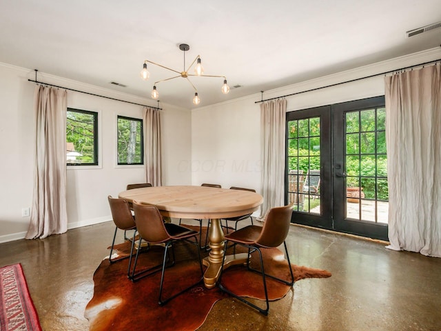 12609 Fancher Rd, Westerville, OH 43082 - dining area with healthy amount of natural light, french doors, crown molding, finished concrete flooring, and a chandelier