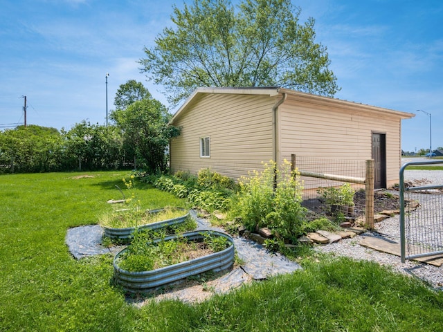 12609 Fancher Rd, Westerville, OH 43082 - view of property exterior featuring a lawn and a vegetable garden