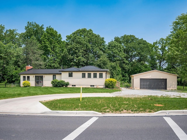 12609 Fancher Rd, Westerville, OH 43082 - single story home with an outdoor structure, a front lawn, a detached garage, a chimney, and a metal roof
