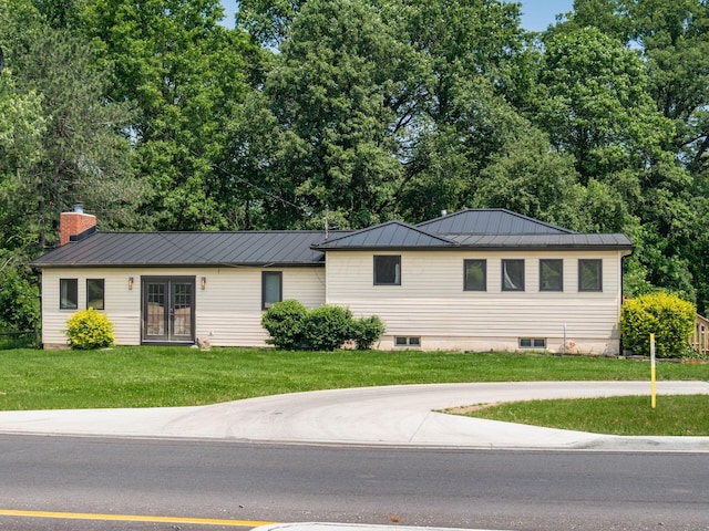 12609 Fancher Rd, Westerville, OH 43082 - ranch-style house featuring french doors, a standing seam roof, a front lawn, a chimney, and a metal roof