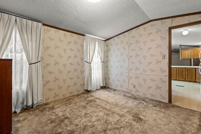 8764 National Rd SW Unit 118, Etna, OH 43062 - spare room featuring crown molding, wallpapered walls, a textured ceiling, carpet flooring, and vaulted ceiling