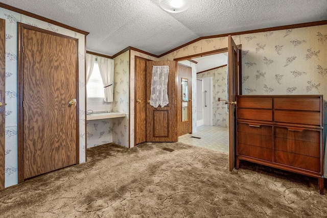 8764 National Rd SW Unit 118, Etna, OH 43062 - unfurnished bedroom featuring wallpapered walls, crown molding, a textured ceiling, carpet floors, and vaulted ceiling