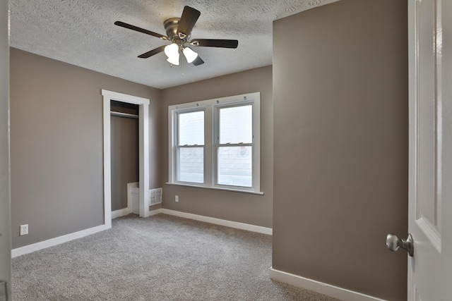 212-214 S Eureka Ave, Columbus, OH 43204 - unfurnished bedroom featuring baseboards, a textured ceiling, carpet floors, a closet, and ceiling fan