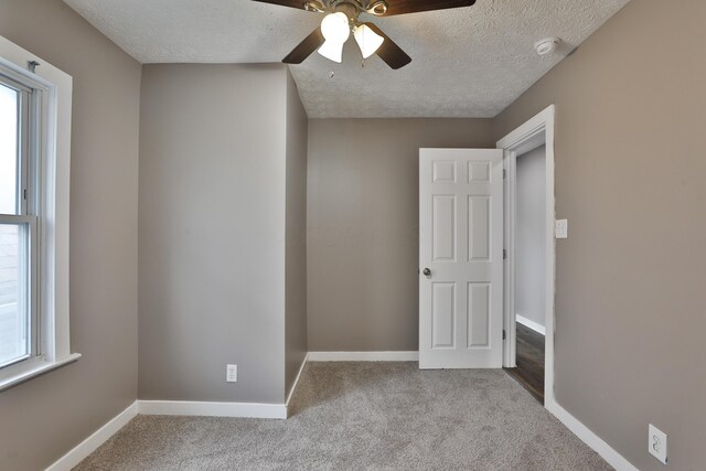 212-214 S Eureka Ave, Columbus, OH 43204 - unfurnished room with carpet, healthy amount of natural light, ceiling fan, a textured ceiling, and baseboards