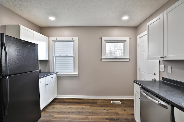 212-214 S Eureka Ave, Columbus, OH 43204 - kitchen with freestanding refrigerator, stainless steel dishwasher, baseboards, dark wood-style flooring, and a textured ceiling