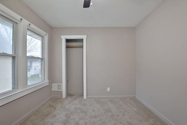 212-214 S Eureka Ave, Columbus, OH 43204 - unfurnished bedroom featuring multiple windows, light colored carpet, and baseboards