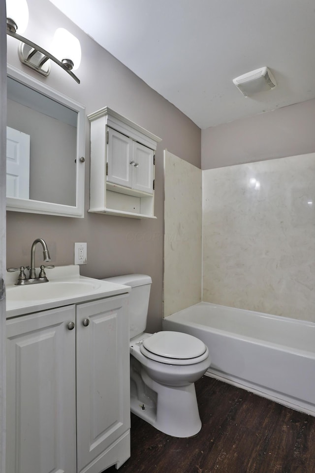 212-214 S Eureka Ave, Columbus, OH 43204 - bathroom featuring wood finished floors, a bath, toilet, and vanity