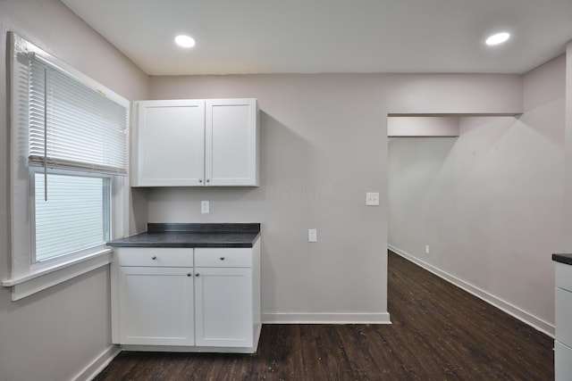 212-214 S Eureka Ave, Columbus, OH 43204 - kitchen with baseboards, dark wood-style flooring, white cabinets, dark countertops, and recessed lighting