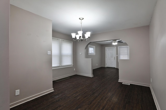 212-214 S Eureka Ave, Columbus, OH 43204 - spare room with arched walkways, dark wood-type flooring, a chandelier, and baseboards