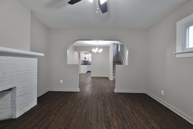 212-214 S Eureka Ave, Columbus, OH 43204 - unfurnished living room featuring a ceiling fan, wood finished floors, a brick fireplace, baseboards, and arched walkways