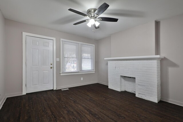 212-214 S Eureka Ave, Columbus, OH 43204 - unfurnished living room with dark wood-style floors, baseboards, a ceiling fan, and a brick fireplace