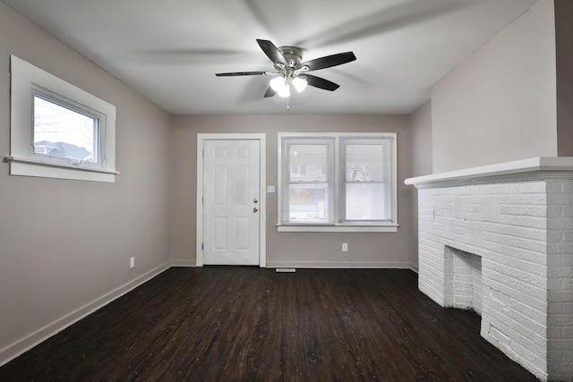 212-214 S Eureka Ave, Columbus, OH 43204 - unfurnished living room with wood finished floors, a ceiling fan, baseboards, and a brick fireplace