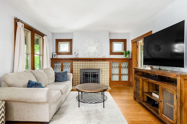 138 E Kelso Rd, Columbus, OH 43202 - living area with light wood-style flooring, healthy amount of natural light, and a tiled fireplace